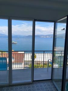 a view of the ocean from a room with sliding glass doors at RIA mar DE BELUSO in Bueu