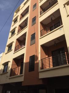 a tall building with balconies on the side of it at Mouna in Dakar