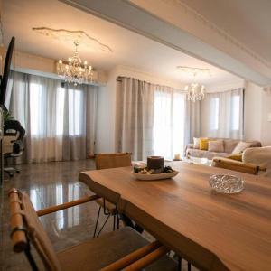 sala de estar amplia con mesa y sofá en Stunning city view apt & parking space at Old town en Tesalónica