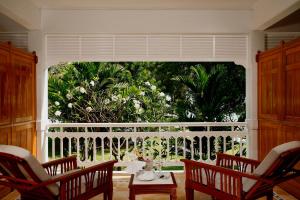 a room with a large window with chairs and a table at Centara Grand Beach Resort & Villas Hua Hin in Hua Hin