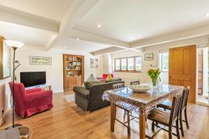 a living room with a table and a couch at The Old School Cottage in Woodsford