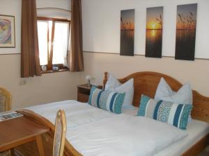 a bedroom with a bed with blue and white pillows at Dowis-Hof in Seebruck