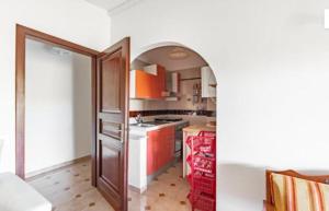 a kitchen with an archway leading into a kitchen with a stove at Casa di Maria a Bosco in San Giovanni a Piro