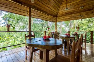 comedor con mesas y sillas en una terraza en Drake Bay Getaway Resort, en Drake