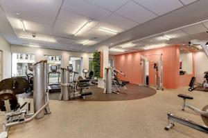 a gym with treadmills and machines in a room at Trendy and Adaptable Accommodation in Crystal City in Arlington