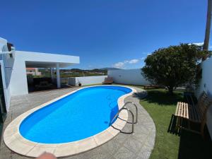 a swimming pool in the backyard of a house at Villa Família in Ponta Delgada