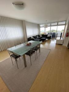 a living room with a green table and chairs at Villa Família in Ponta Delgada