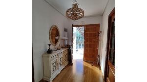 a hallway with a mirror and a dresser at Casa Meri in El Espino