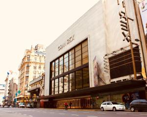 a building on a city street with a car parked in front at Obelisco 818 in Buenos Aires