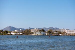 a large body of water with people kayaking in it at Villa Tamarells - Alcúdia in Alcudia +27 photos