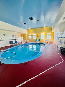 a large swimming pool in a large room at Super 8 by Wyndham Elizabethtown in Elizabethtown