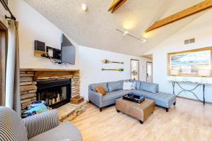 a living room with a couch and a fireplace at Moon Lodge in Reeds Spring