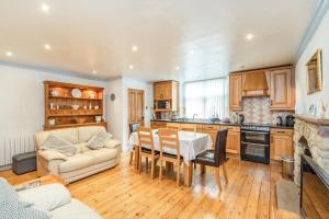 een keuken en een woonkamer met een bank en een tafel bij Prospect House in Leyburn