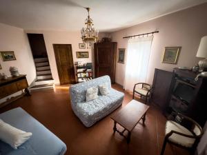 a living room with a couch and a chair at La Torretta, una casa inaspettata in Mesola