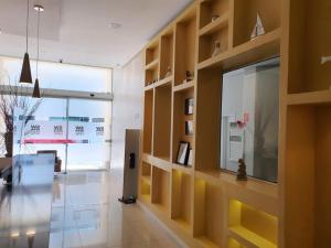 a living room with a large glass wall at SW Praia Hotel in Praia Grande