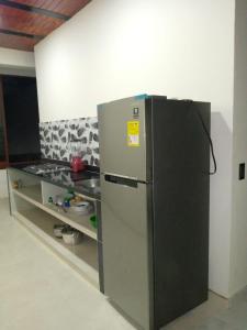 a stainless steel refrigerator in a kitchen with a shelf at hermoso apartamento en guaduas (apto 202) in Guaduas