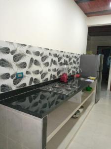 a counter in a kitchen with a black and white wall at hermoso apartamento en guaduas (apto 202) in Guaduas