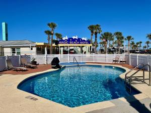 a swimming pool with a pool table in front of it at Magic Beach Motel - Vilano Beach, Saint Augustine in Saint Augustine