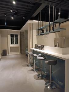 a kitchen with a bar with stools in it at Castle On A Cloud in Renai