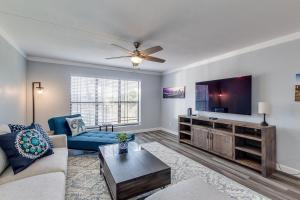 a living room with a couch and a flat screen tv at Stunning Golf and Water Views with Large Patio! Biltmore Terrace! condo in Phoenix