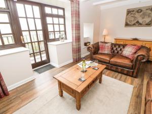 a living room with a couch and a coffee table at Bank Cottage in Alston