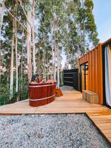 two people sitting in a hot tub on a wooden deck at Container ABOBORA na natureza da Serra Gaúcha in Flores da Cunha +10 photos