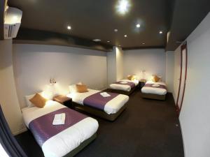 a room with three beds in a room at Hotel S-Presso West - Vacation STAY 9085 in Osaka