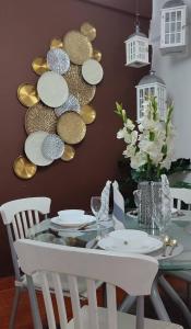 a dining room with a glass table with white chairs at Maya Homestay Putrajaya in Putrajaya