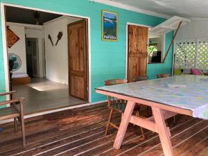 
a room with a wooden floor and wooden walls at Manomano Lodge in Papara

