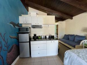a kitchen with a stove and a bed at Magic Beach Motel - Vilano Beach, Saint Augustine in Saint Augustine