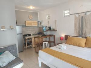 a small bedroom with a bed and a kitchen at Kika Studios in Playa del Carmen