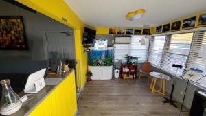 a kitchen with yellow walls and a fish tank at American Inn in Washington