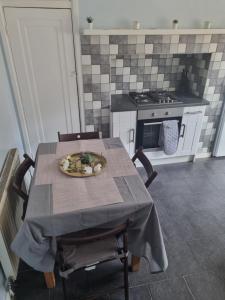 a kitchen with a table with a plate on it at Lovely residential home 2 bed apartments in Goodmayes