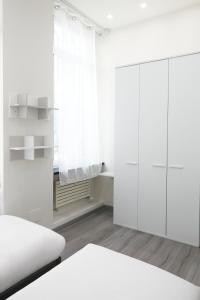 a white bedroom with a bed and a closet at LA CORTE LUXURY APARTMENT in Milan
