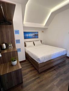 Postel nebo postele na pokoji v ubytování MSing DaLat Hotel