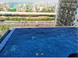 a large swimming pool on the side of a building at Best Western PLUS Runway in Dhaka