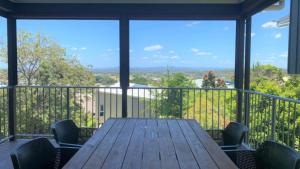 a table and chairs on a balcony with a view at Saltys Place, Pet Friendly and Close To Beach in Caloundra