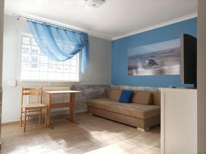 a living room with a couch and a table at Pod Jaskółką in Ustka