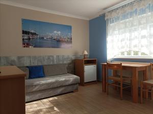 a living room with a couch and a table at Pod Jaskółką in Ustka