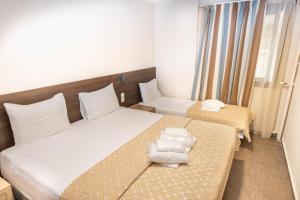 Ένα ή περισσότερα κρεβάτια σε δωμάτιο στο Ξενοδοχείο Ανίτα