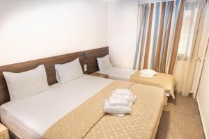 Postel nebo postele na pokoji v ubytování Anita Hotel