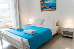 a bedroom with a bed with two towels on it at Villa Kallithea in Parga