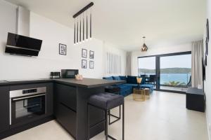 a kitchen and living room with a view of the ocean at Ero on the beach in Trogir
