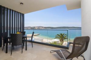 a dining room with a view of the ocean at Ero on the beach in Trogir
