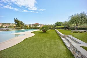 a park with a bench and a swimming pool at Appartamento Monolocale Rebi in Imperia