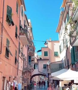 a street in an old town with people walking down it at Affittacamere Sull'Arco in Monterosso al Mare