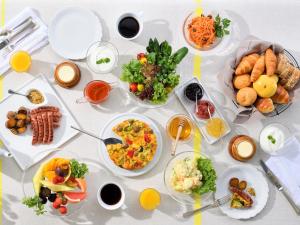 a table with many plates of food on it at Hotel Intergate Kanazawa in Kanazawa