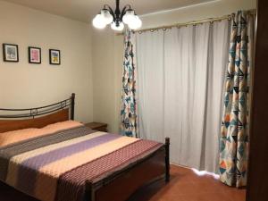 a bedroom with a bed and a window with curtains at Apartment in Golf Porto Marina in El Alamein