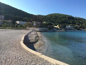 a beach with a town and the water at Concordia Apartments in Dubrovnik
