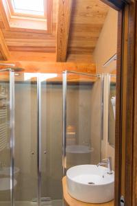 a bathroom with a sink and a shower at LA PLACETTE - Albergo diffuso e trattoria in Usseaux